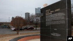 FILE - A memorial to Tulsa's Black Wall Street sits outside the Greenwood Cultural Center on the outskirts of downtown Tulsa, Okla., Dec. 15, 2016. The once-prosperous section of Tulsa became the site of one of the worst race riots in American history.