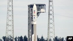 A United Launch Alliance Atlas V rocket that will launch to Mars arrives at Space Launch Complex 41 at the Cape Canaveral Air Force Station, Tuesday, July 28, 2020, in Cape Canaveral, Fla. (AP Photo/John Raoux)