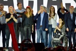 President Mauricio Macri, who was running for re-election, throws a kiss to supporters after conceding the election in Buenos Aires, Argentina, Oct. 27, 2019.