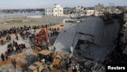 แฟ้มภาพ: ชาวปาเลสไตน์ที่ลี้ภัยมาอยู่ที่เมืองราฟาห์ ทางใต้ของฉนวนกาซ่า ตรวจสอบบ้านหลังหนึ่งที่ถูกโจมตีโดยอิสราเอล เมื่อวันที่ 16 ก.พ. 2567