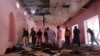Police officers and rescue workers gather at the site after a blast in a mosque in Quetta, Pakistan, May 24, 2019. 