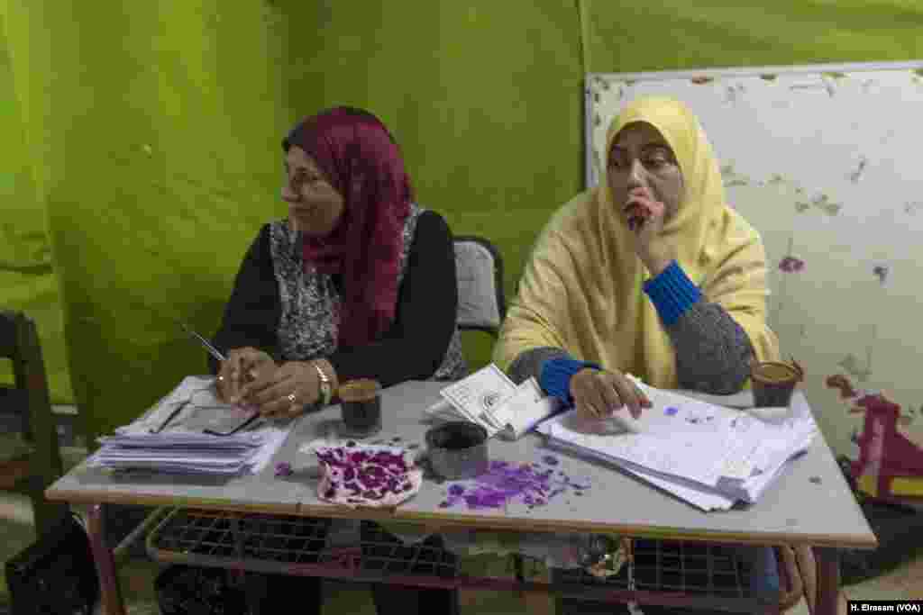 Workers at a polling station in Cairo have coffee while waiting for voters to show up, March 27, 2018. 