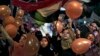Supporters of Egypt's ousted President Mohamed Morsi hold balloons and national flags as they celebrate the first day of the Eid al-Fitr feast, Cairo, August 8, 2013. 