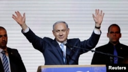 Israeli Prime Minister Benjamin Netanyahu waves to supporters at the party headquarters in Tel Aviv, March 18, 2015.