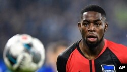 FILE - Berlin's Jordan Torunarigha looks at the ball during the German soccer cup, DFB Pokal, match between FC Schalke 04 and Hertha BSC Berlin in Gelsenkirchen, Germany, Feb. 4, 2020. 