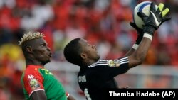 Burkina Faso’s Aristide Bance, left, is stopped in the air by Equatorial Guinea's goalkeeper Felipe Ovono, right, Wednesday, Jan. 21, 2015. (AP)