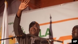 Newly elected president of Burkina Faso, Roch Marc Kabore, waves at supporters after preliminary results showed him to be the winner of recent elections, outside his campaign headquarters in Ouagadougou, Burkina Faso, Dec. 1, 2015. Kabore took the oath of office on Dec. 29, 2015.