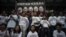 Protesters stand under a banner as they prepare to go on a hunger strike to call for &quot;true&quot; universal suffrage in Hong Kong, March 28, 2014.