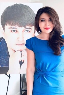 Rayhan Asat stands before a picture of her brother, Ekpar Asat.