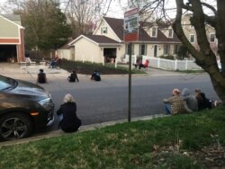 Neighbors watch Bill Crandall play his guitar from his garage in Takoma Park, Maryland. (Mariama Diallo/VOA)