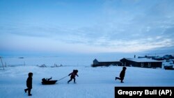Children play in the snow Saturday, Jan. 18, 2020, in Toksook Bay, Alaska. The first Americans to be counted in the 2020 Census starting Tuesday, Jan. 21, live in this Bering Sea coastal village. (AP Photo/Gregory Bull)