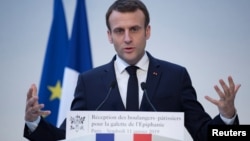 FILE - French President Emmanuel Macron delivers a speech during a traditional epiphany cake ceremony at the Elysee palace in Paris, France, Jan. 11, 2019.