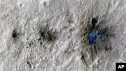 This undated photo released by NASA shows craters that were formed by a Sept. 5, 2021, by a meteoroid impact on Mars, the first to be detected by NASA’s InSight lander. (NASA/JPL-Caltech/University of Arizona via AP)