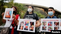 FILE - People protest in front of the Bolivarian National Intelligence Service (SEBIN) headquarters, seeking freedom for political prisoners during the visit of the International Criminal Court's Prosecutor Karim Khan, in Caracas, Venezuela, Nov. 3, 2021.