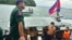 Chinese nationals get off from a speedboat after being rescued from a ship sinking, at an island in Preah Sihanouk Province, southwestern Cambodia on Thursday, Sept. 22, 2022. (Preah Sihanouk province Authority Police via AP) 