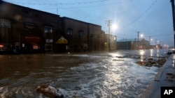 Water rushes down Front Street, just a half block from the Bering Sea, in Nome, Alaska, on Saturday, Sept. 17, 2022. 