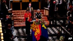 The Imperial State Crown is removed from the coffin during the Committal Service for Queen Elizabeth at St. George's Chapel, at Windsor Castle, Windsor, Sept. 19, 2022.