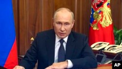 In this image made from video released by the Russian Presidential Press Service, Russian President Vladimir Putin addresses the nation in Moscow, Russia, Wednesday, Sept. 21, 2022. (Russian Presidential Press Service via AP)