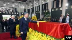 This picture taken and released by the Vietnam News Agency (VNA) on July 25, 2024 shows Vietnamese President To Lam paying his respects for the late general secretary of the Communist Party Nguyen Phu Trong in Hanoi.