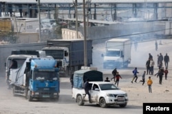 FILE - Trucks carrying aid arrive, amid the ongoing conflict between Israel and the Palestinian Islamist group Hamas, in Rafah in the southern Gaza Strip, Jan. 17, 2024.