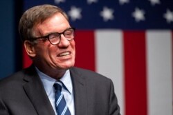 FILE - Sen. Mark Warner, D-Va., addresses the news media in Alexandria, Va., Nov. 3, 2020.