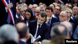 French President Emmanuel Macron attends a meeting with mayors from rural Normandy as part of the launching of the "Great National Debate" designed to find ways to calm social unrest in the country, in Grand Bourgtheroulde, France, Jan. 15, 2019. 