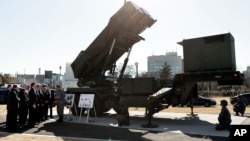 FILE - U.S. Vice President Mike Pence inspects the Patriot Advanced Capability-3 (PAC-3) missile launch system with Itsunori Onodera, Japan's defense minister, during a demonstration at the Ministry of Defense in Tokyo, Japan, Feb. 7, 2018. 
