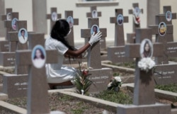FILE - A family member of one of the victims killed at St. Sebastian's church, one of the churches attacked in the April 21, 2019, Easter Sunday bombings, reacts at a cemetery on the first year anniversary of the blasts, in Katuwapitiya village.