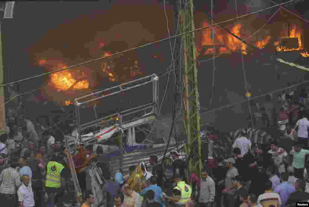 Cars burn at the site of an explosion in Beirut's southern suburbs, August 15, 2013.