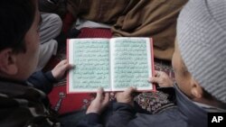 Afghans jointly read Islam's holy book "Quran" during a celebration to mark the anniversary birthday of Islam's Prophet Mohammad at a mosque in Kabul, Afghanistan, February 4, 2012.