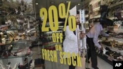 A customer leaves a shoe store in Mumbai January 31, 2012.