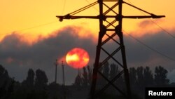 FILE - An electricity transmission tower is seen on the outskirts of the town of Lozova, some 450 km (280 miles) east of Ukraine's capital Kyiv.