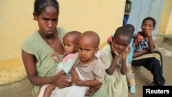 Tsegy Kiday, a 34-year-old displaced single mother, is seen with her five children in Nebelet, Tigray region, Ethiopia, July 11, 2021.