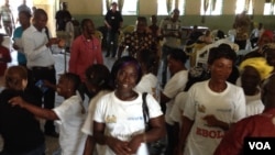 Jamilah Jawara, an Ebola survivor, dances in celebration with fellow survivors, Kenema, Sierra Leone, Oct. 17, 2014. (Nina Devries / VOA)
