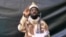 FILE - A grab made on July 13, 2013 from a video obtained by AFP shows the leader of the Islamist extremist group Boko Haram Abubakar Shekau, dressed in camouflage and holding an Kalashnikov AK-47. 
