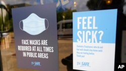 Face mask requirements are posted at the various entrances at the Rose E. McCoy Auditorium where COVID-19 vaccinations are being offered on the Jackson State University campus in Jackson, Miss., July 27, 2021. 