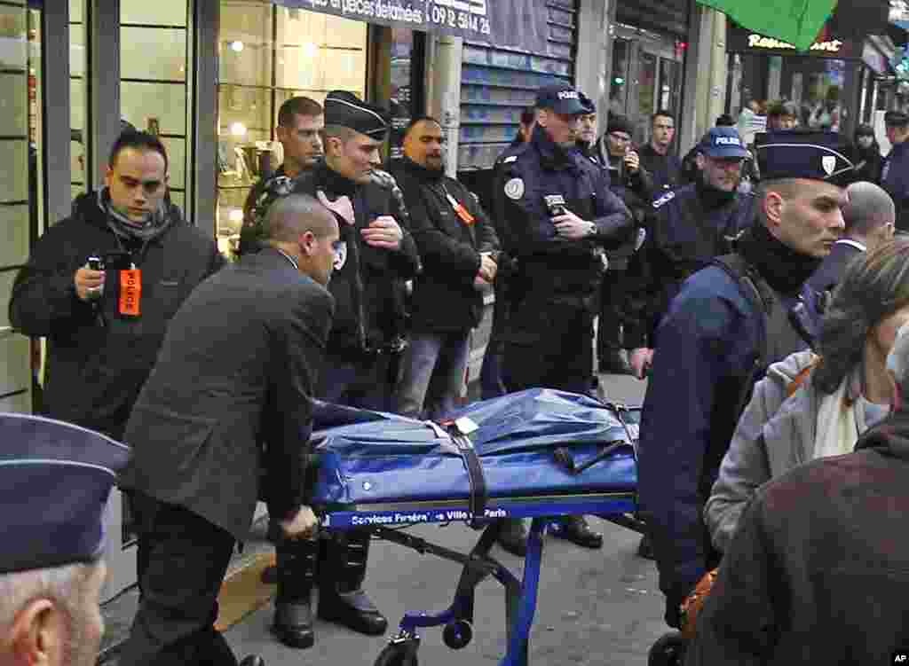 The body of one of three Kurdish women is taken out of the building where they were killed, Paris, France, January 10, 2013.