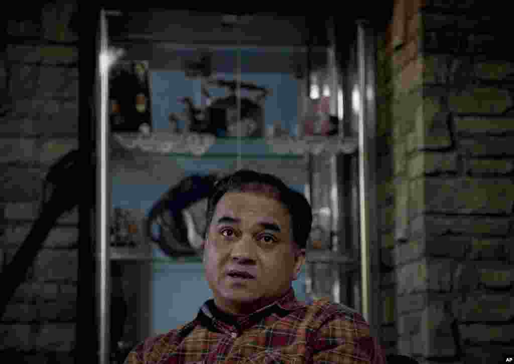 In this Feb. 4, 2013 photo, Ilham Tohti, an outspoken scholar of China&#39;s Turkic Uighur ethnic minority, pauses during an interview at his home in Beijing, China. Tohti was set to go on trial on separatism charges on Sept. 17, 2014. 