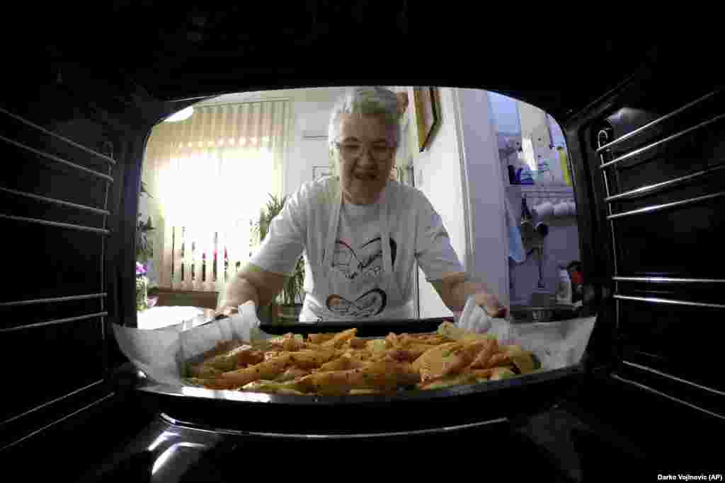 Serbia Granny's Kitchen: Jelena Petrovic places the tray with food into the oven