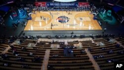 Fans watch Georgetown play Creighton during the second half of an NCAA college basketball game for the championship of the Big East men's tournament Saturday, March 13, 2021, in New York. Georgetown won 73-48. (AP Photo/Frank Franklin II)
