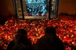 People place candles at a memorial to commemorate the 30th anniversary of the so-called Velvet Revolution in Prague, Czech Republic. The peaceful revolution toppled the Communist regime in former Czechoslovakia 30 years ago.
