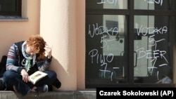 A girl reads a book in Warsaw, Poland, April 26, 2016. (AP Photo/Czarek Sokolowski)