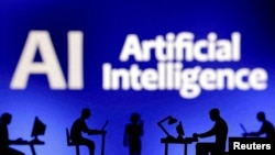 FILE - Figurines with computers and smartphones are seen in front of the words "Artificial Intelligence AI" in this illustration photo taken Feb. 19, 2024. Experts say supporters of the Islamic State terror group are increasingly relying on AI to generate online propaganda.