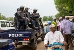 FILE - Malian police gather outside the Bourse du Travail where striking workers gathered to protest the arrest of President Bah N'Daw and Prime Minister Moctar Ouane by military personnel in Bamako, Mali, May 25, 2021.