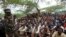 FILE - Members of the militant group al-Shabab listen to a Somalia government soldier after their surrender to the authorities in Mogadishu, Sept. 24, 2012.