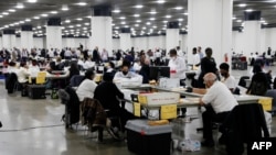 Election workers count absentee ballots sent in for the 2020 U.S. election at TCF Center in Detroit, Michigan, Nov. 4, 2020.