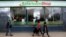 Pedestrians walk past a mobile phone care centre operated by Kenyan's telecom operator Safaricom in the central business district of Kenya's capital Nairobi, May 11, 2016.