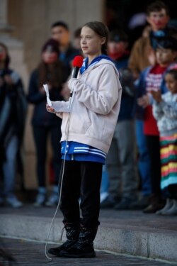 FILE - Bundled up against cool temperatures, Swedish climate activist Greta Thunberg speaks to several thousand people at a climate strike rally, Oct. 11, 2019, in Denver. The rally was staged in Denver's Civic Center Park.