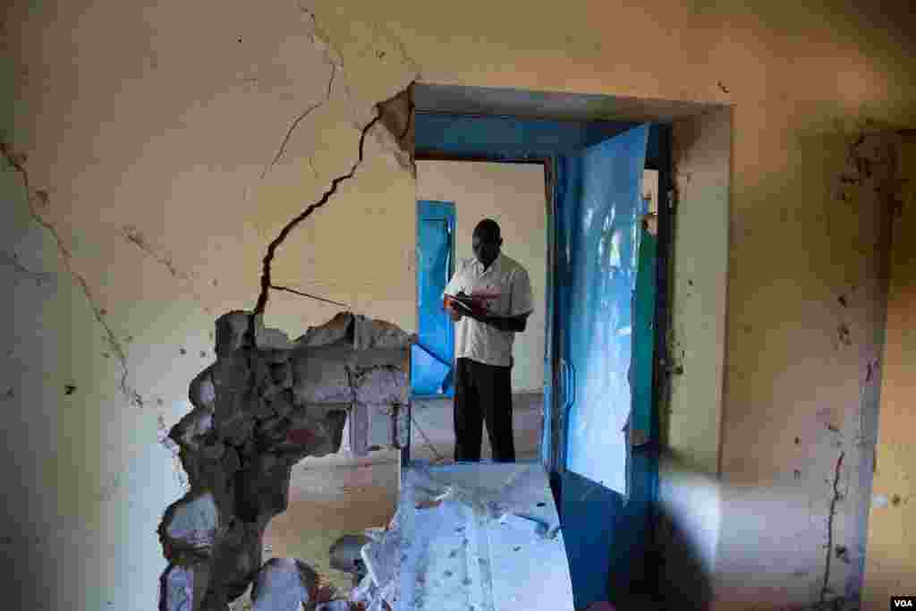 Partially collapsed building of the famed Carlton Citadel Hotel (L), in the government-controlled side of the divided northern Syrian city of Aleppo