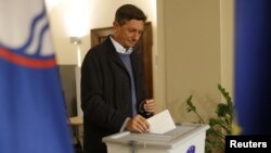 A person walks through the grounds of the Parish Church of Saint Mary and All Saints, in Whitmore, Staffordshire, Britain.
